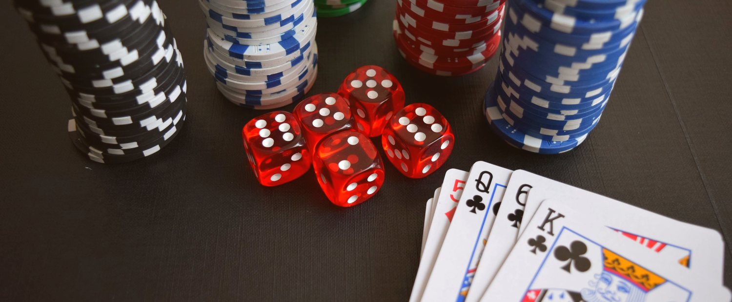 Red felt poker table with stacked casino chips — the live cash games where the 2015 KhanZ bot ring left its forensic trail